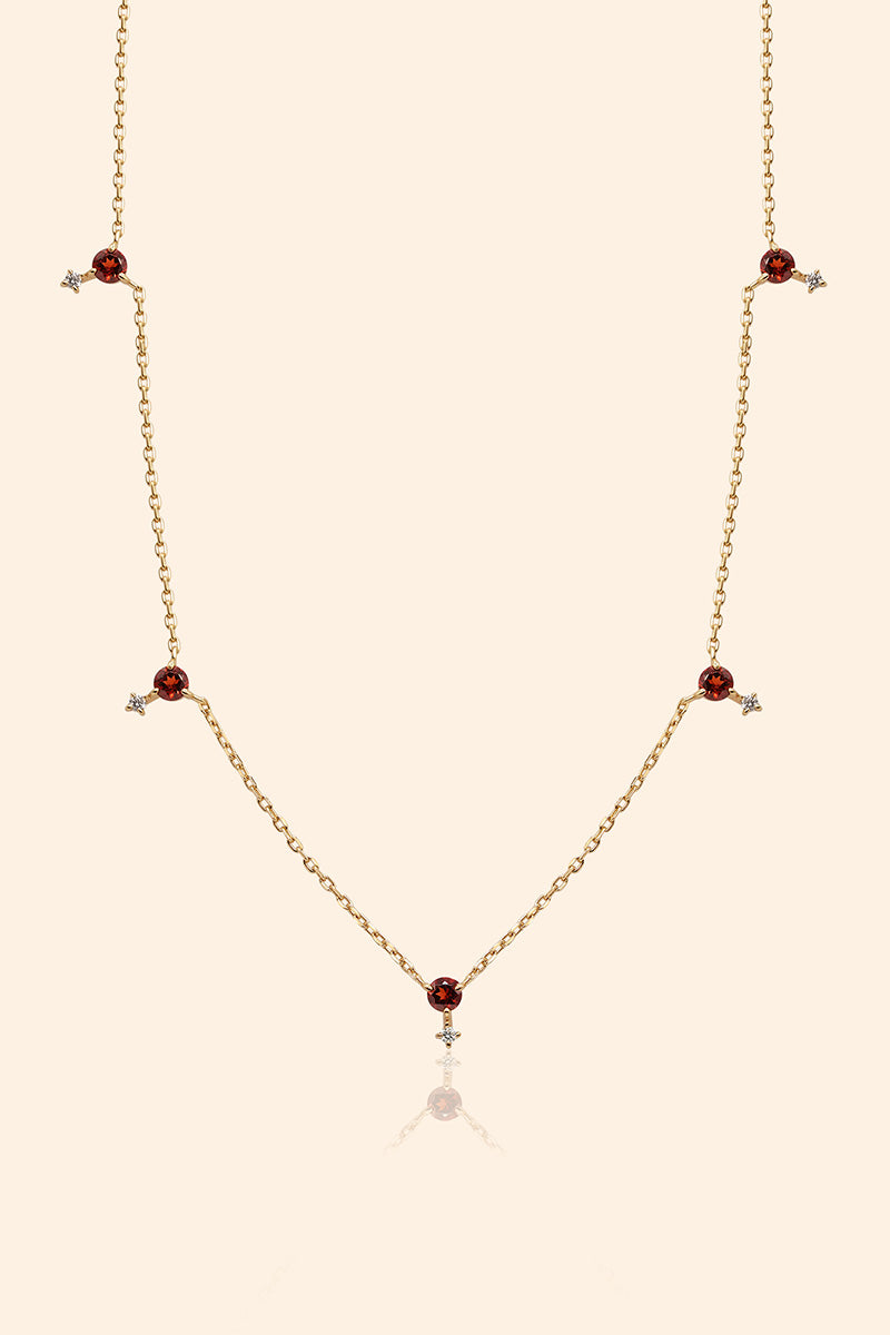 Dainty gold garnet station necklace with sparkling moissanite star accents
