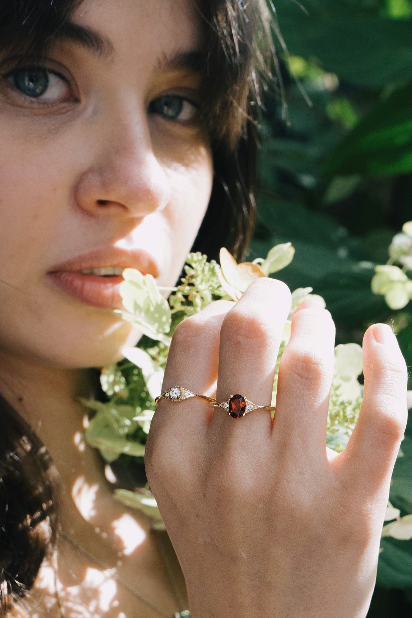 LIRAE vintage-style gold ring featuring an oval red garnet center stone and geometric rhombus accents with milgrain detailing, Art Deco stacking jewelry.
