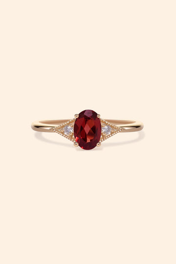 LIRAE vintage-style gold ring featuring an oval red garnet center stone and geometric rhombus accents with milgrain detailing, Art Deco stacking jewelry.
