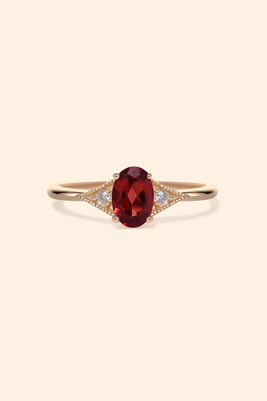 LIRAE vintage-style gold ring featuring an oval red garnet center stone and geometric rhombus accents with milgrain detailing, Art Deco stacking jewelry.