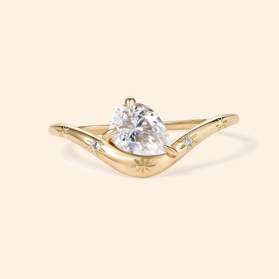 Gold vermeil pear cut diamond ring with engraved star details.