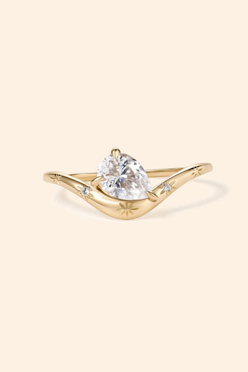 Gold vermeil pear cut diamond ring with engraved star details.