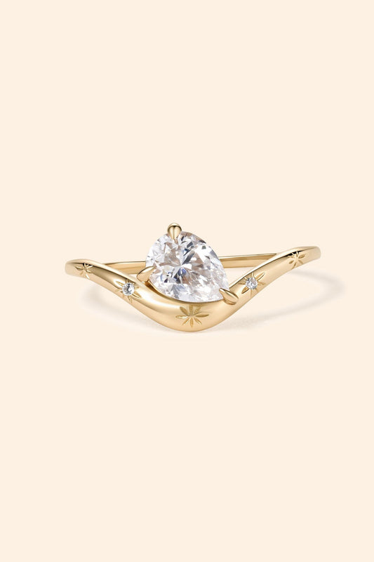 Gold vermeil pear cut diamond ring with engraved star details.