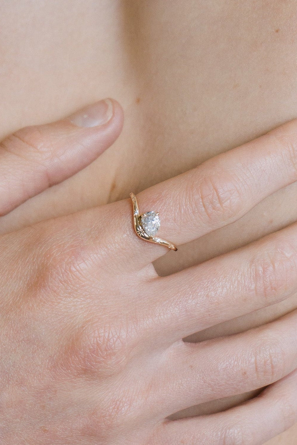 Gold vermeil pear cut diamond ring with engraved star details.