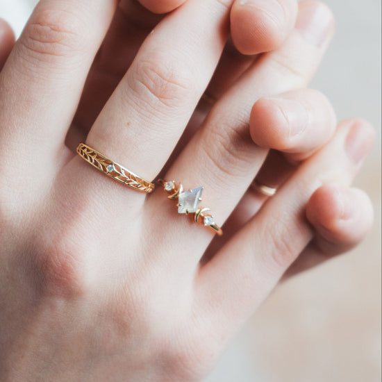 LIRAE celestial ring featuring a kite cut labradorite center stone and gold crescent moons, witchy aesthetic galaxy jewelry for women.