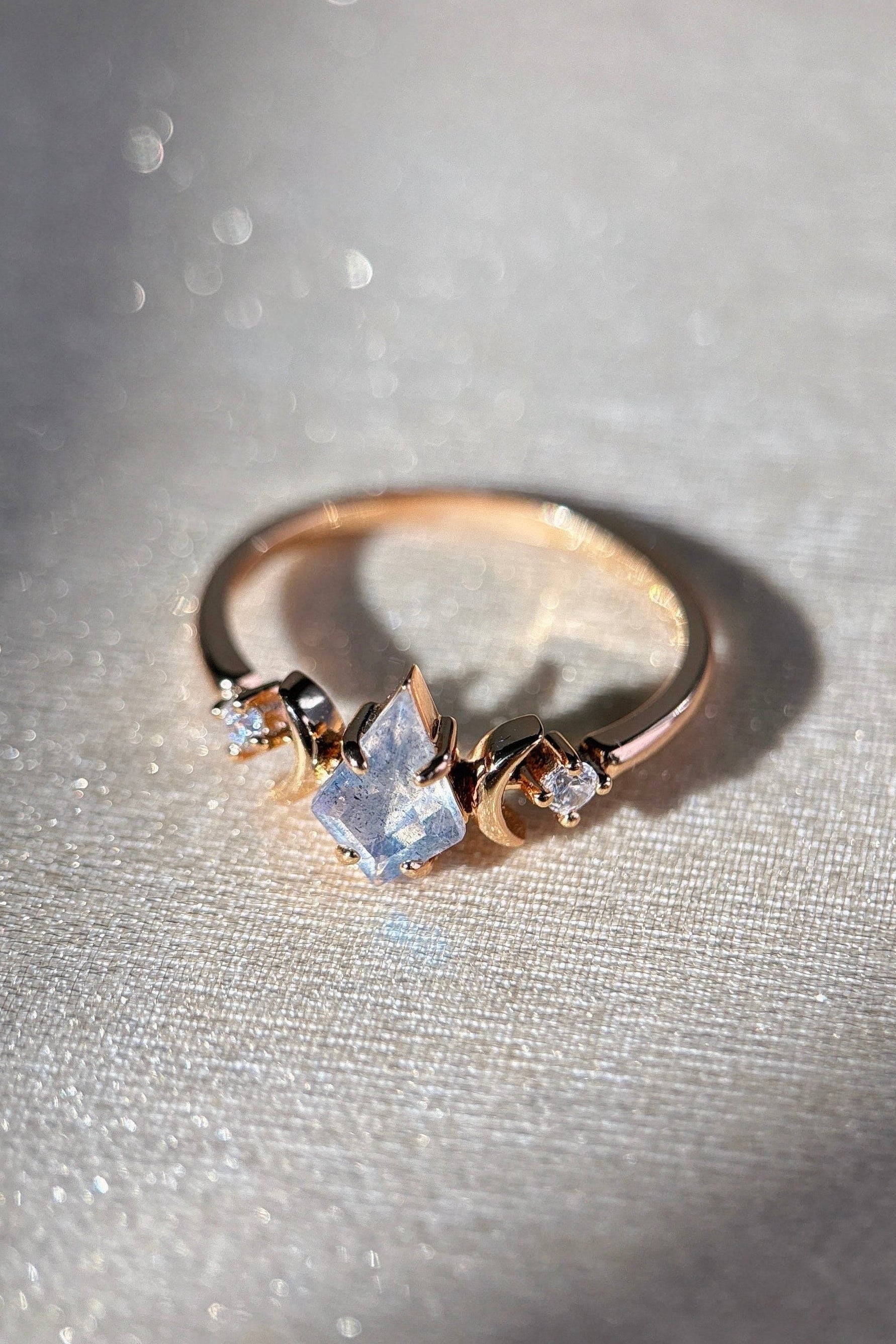 LIRAE celestial ring featuring a kite cut labradorite center stone and gold crescent moons, witchy aesthetic galaxy jewelry for women.
