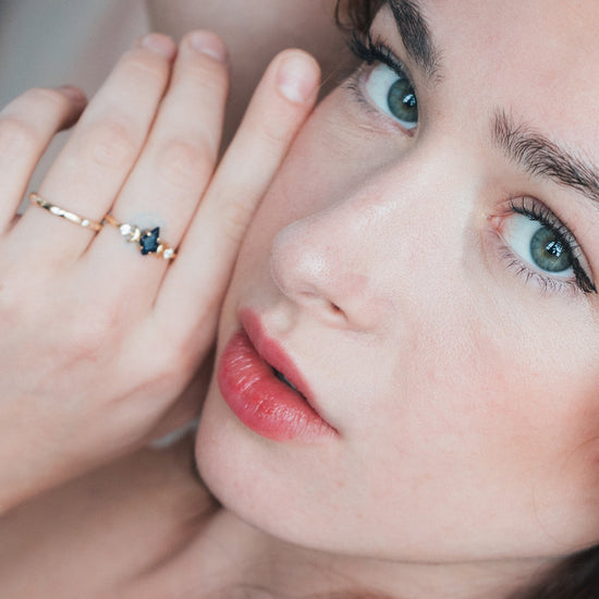 LIRAE celestial ring featuring a kite cut sandstone center stone and gold crescent moons, witchy aesthetic galaxy jewelry for women.