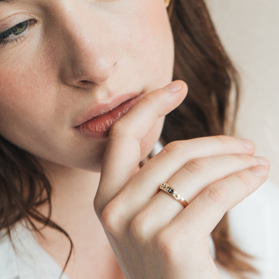 Gold celestial star ring with deep blue lapis lazuli inlay and engraved sun moon details