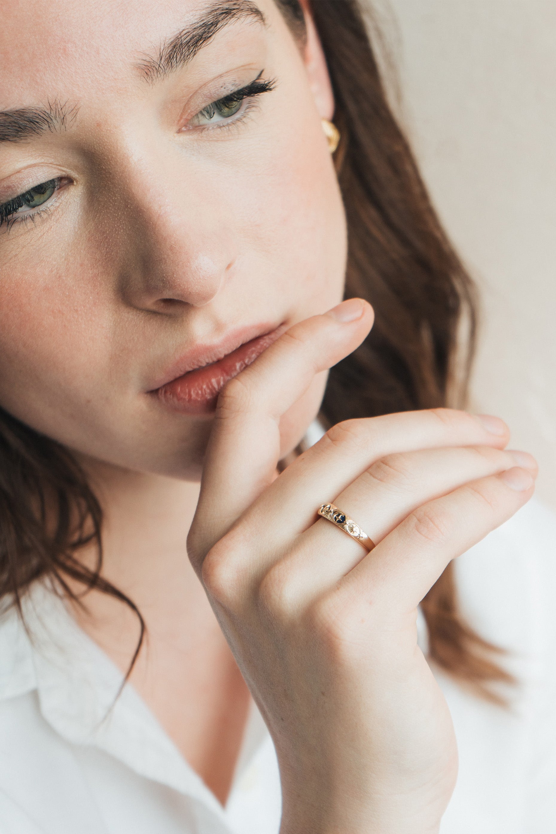 Gold celestial star ring with deep blue lapis lazuli inlay and engraved sun moon details