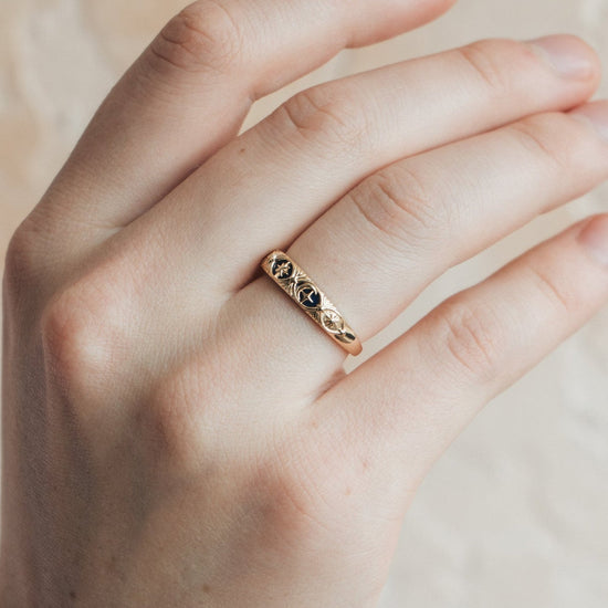 Gold celestial star ring with deep blue lapis lazuli inlay and engraved sun moon details