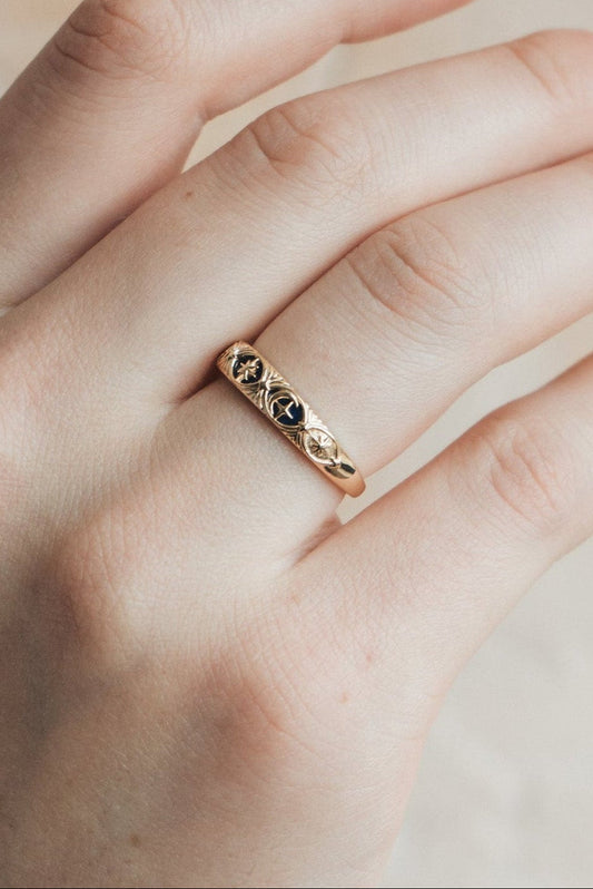Gold celestial star ring with deep blue lapis lazuli inlay and engraved sun moon details