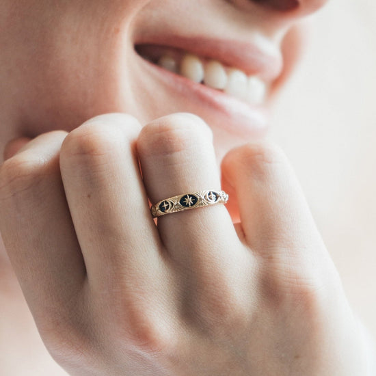 Gold celestial star ring with deep blue lapis lazuli inlay and engraved sun moon details