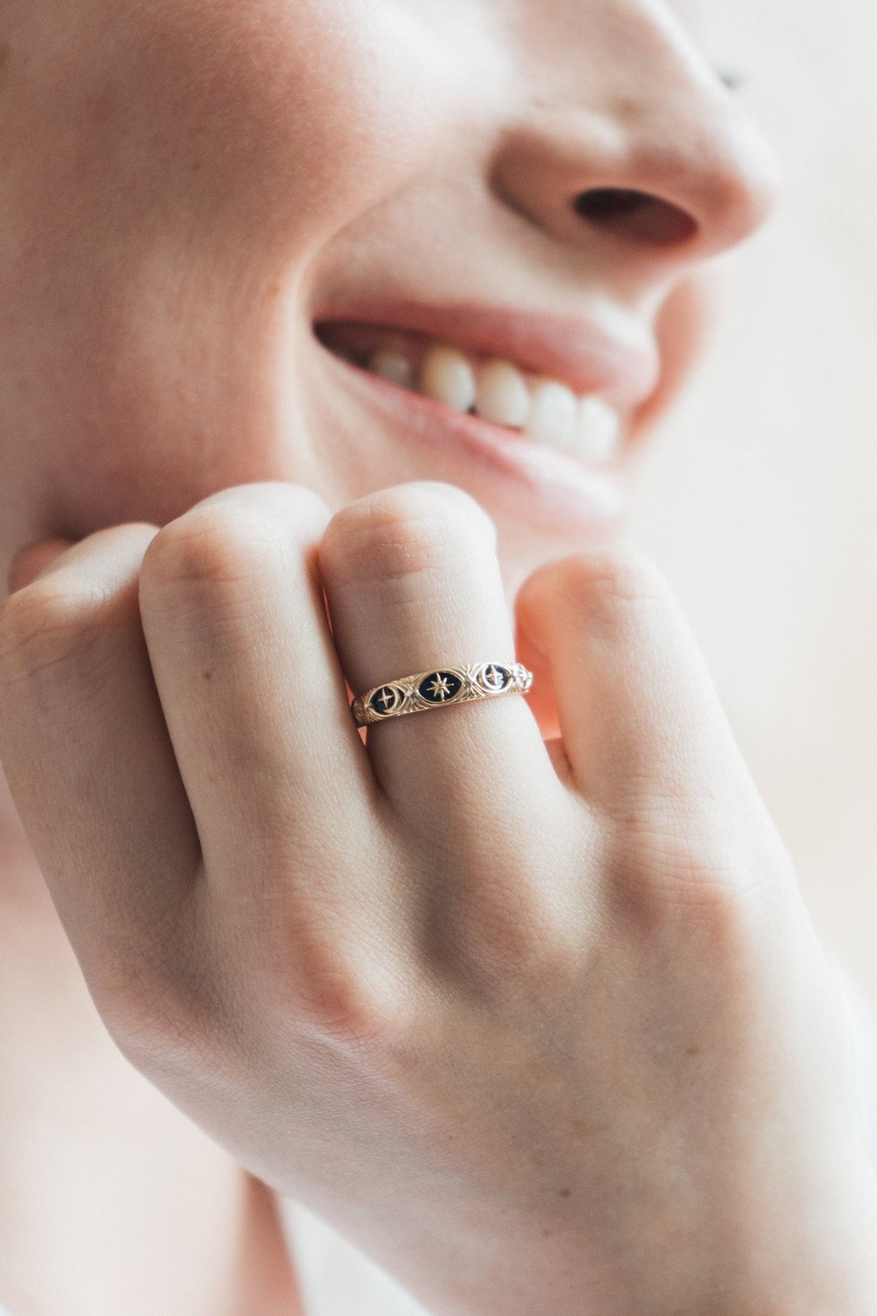 Gold celestial star ring with deep blue lapis lazuli inlay and engraved sun moon details
