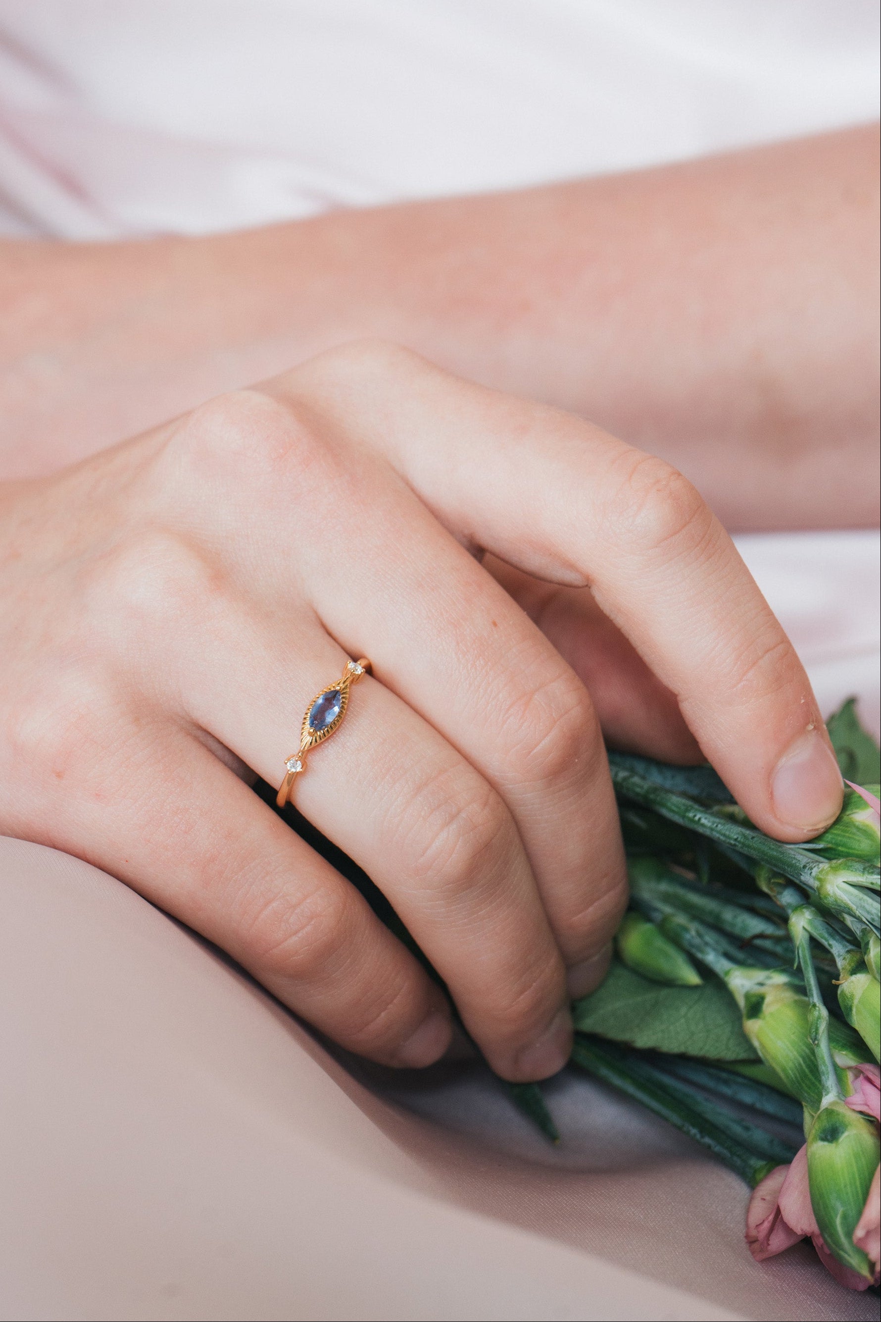 Dainty gold iolite eye ring with marquise purple-blue center stone and sparkling side stones