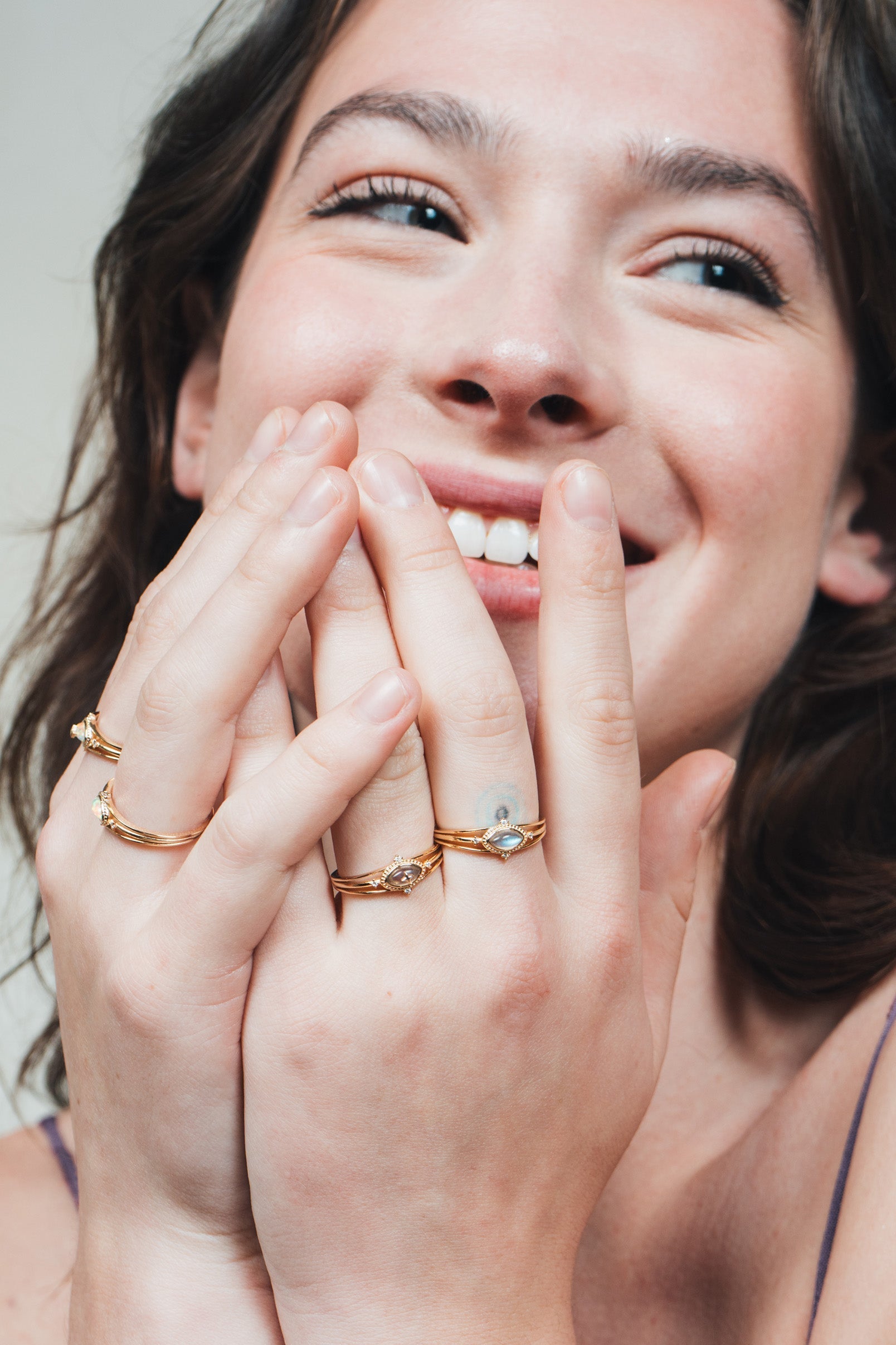 Marquise-cut flashy labradorite ring in 14k gold with a triple-band design and gold north star accent, ethereal celestial jewelry by LIRAE.