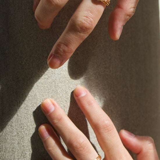 Marquise-cut flashy labradorite ring in 14k gold with a triple-band design and gold north star accent, ethereal celestial jewelry by LIRAE.
