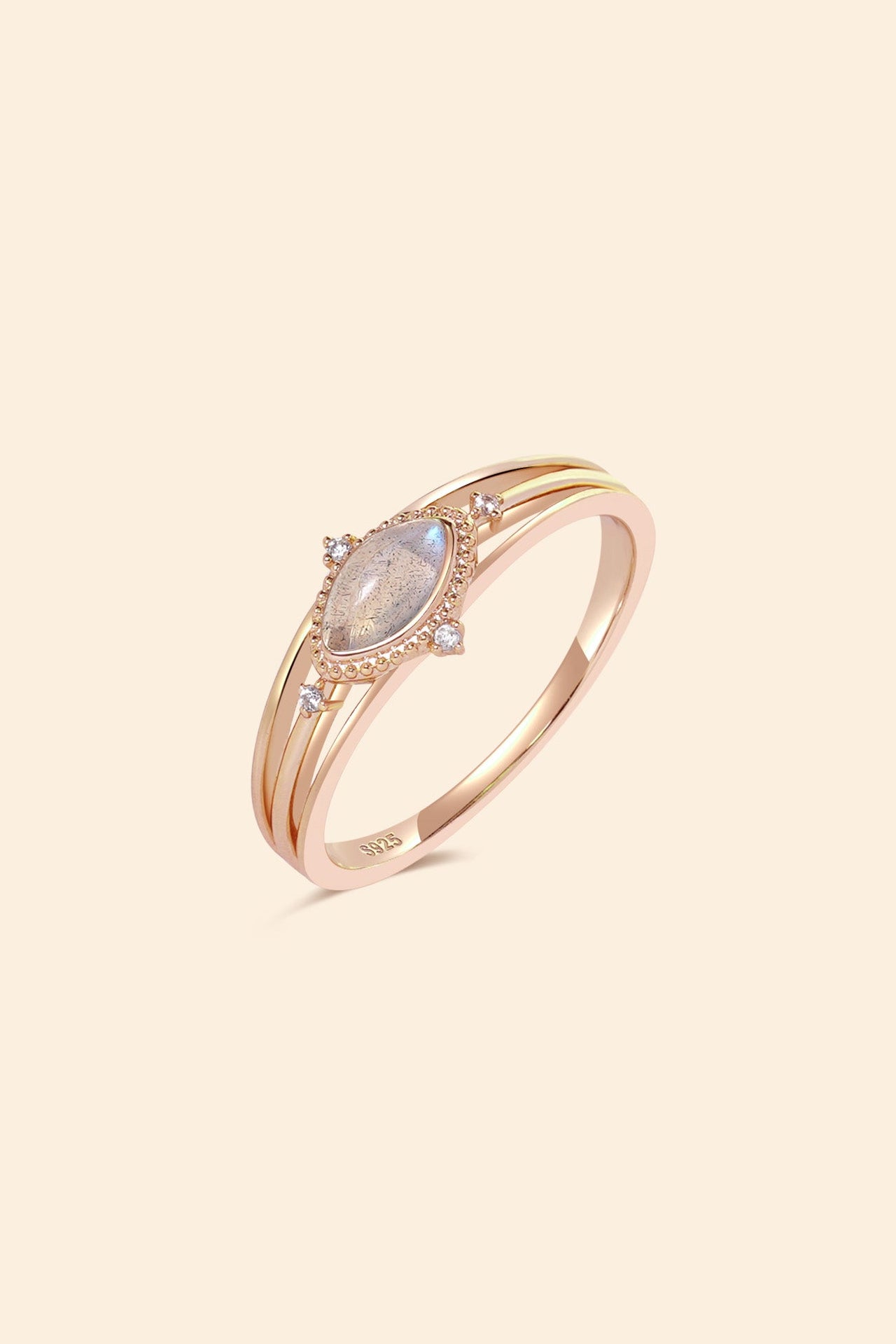 Marquise-cut flashy labradorite ring in 14k gold with a triple-band design and gold north star accent, ethereal celestial jewelry by LIRAE.