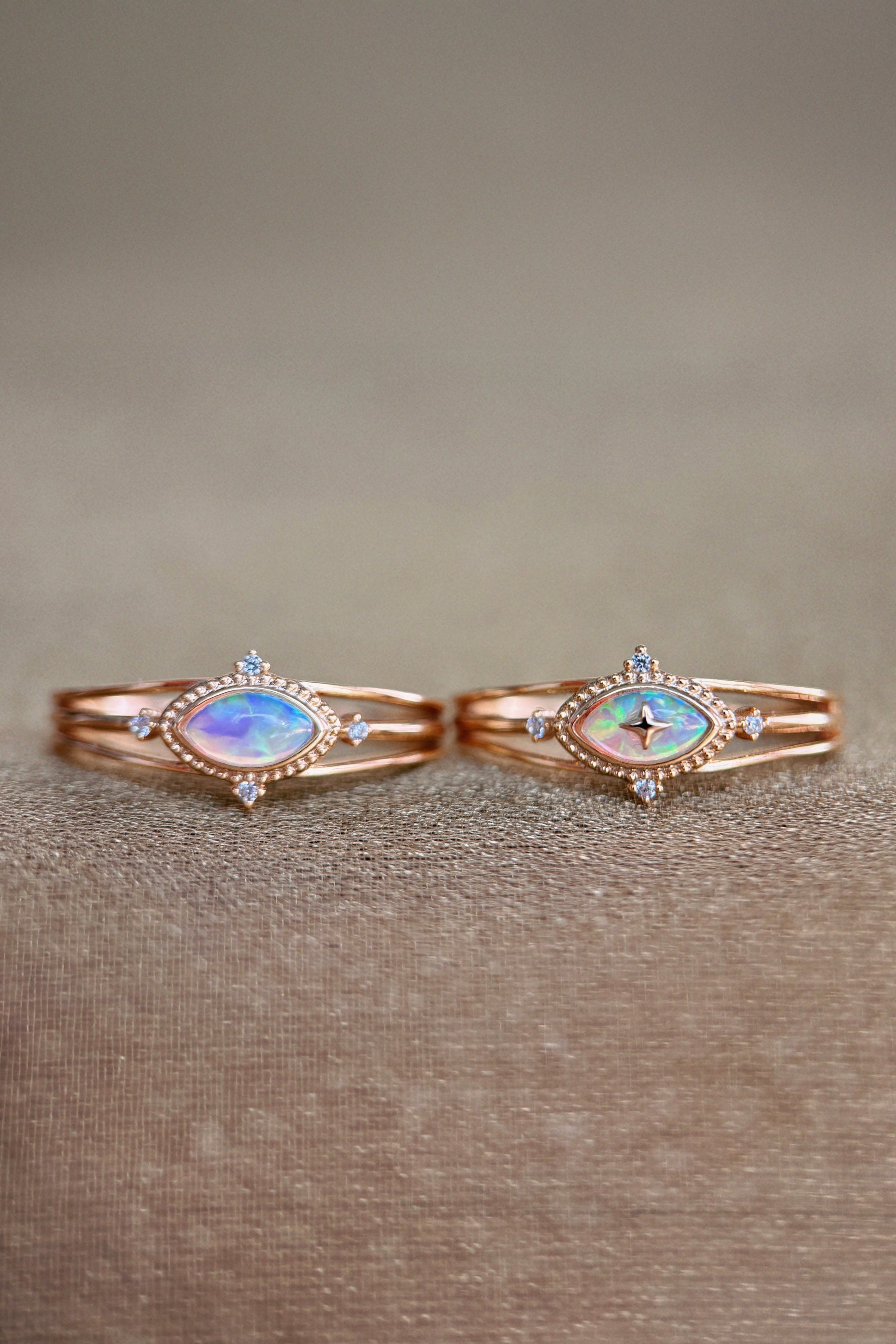 Marquise-cut iridescent opal ring in 14k gold with a triple-band design and north star accents, ethereal celestial jewelry by LIRAE.