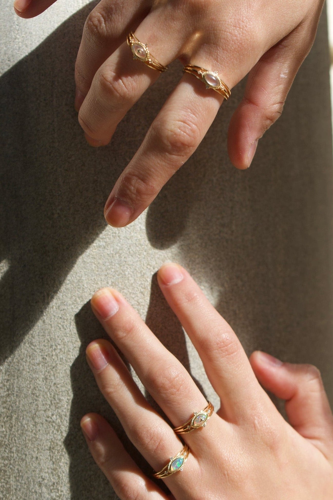 Marquise-cut iridescent opal ring in 14k gold with a triple-band design and north star accents, ethereal celestial jewelry by LIRAE.