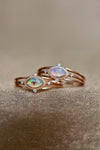 Marquise-cut iridescent opal ring in 14k gold with a triple-band design and north star accents, ethereal celestial jewelry by LIRAE.