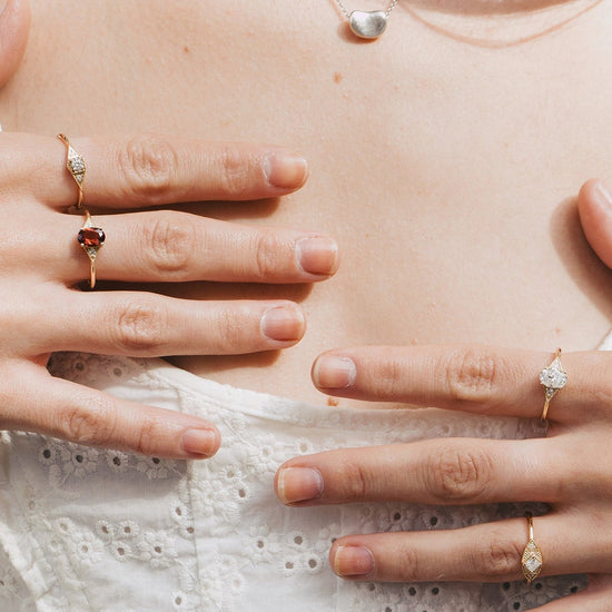 LIRAE Art Deco gold ring featuring a geometric rhombus design with milgrain edges and three moissanites, vintage-inspired stackable jewelry.