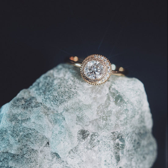 Gold halo ring with round center moissanite stone