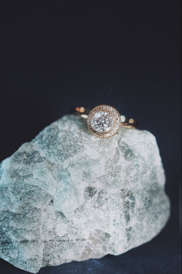 Gold halo ring with round center moissanite stone
