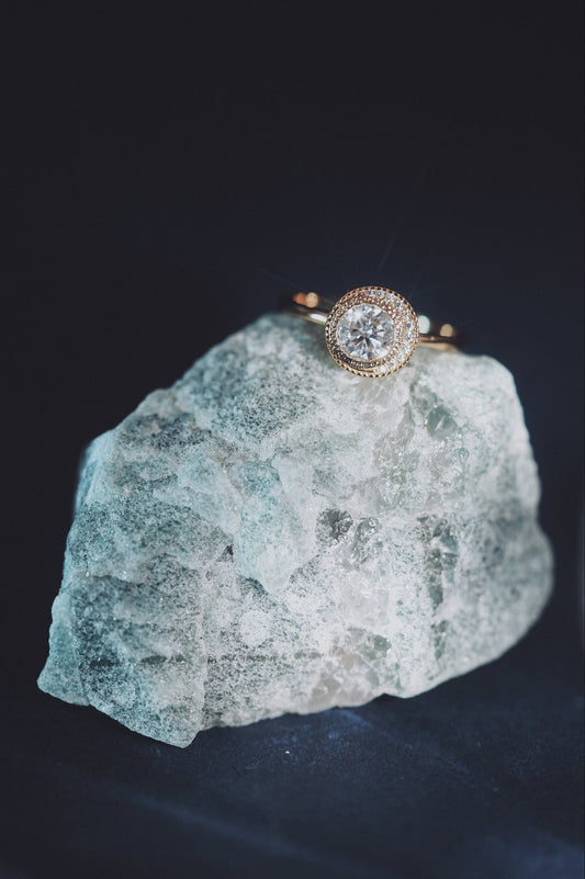 Gold halo ring with round center moissanite stone