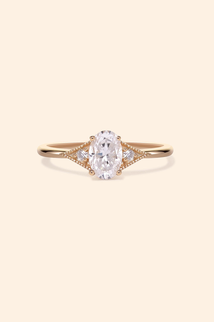 LIRAE vintage-style gold ring featuring an oval moissanite center stone and geometric rhombus accents with milgrain detailing, Art Deco stacking jewelry.
