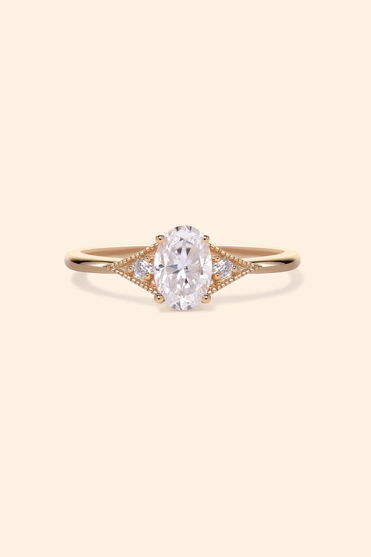 LIRAE vintage-style gold ring featuring an oval moissanite center stone and geometric rhombus accents with milgrain detailing, Art Deco stacking jewelry.
