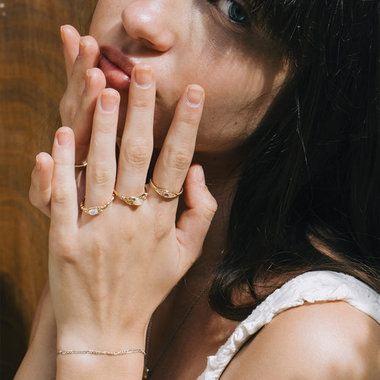 LIRAE moonstone ring featuring golden swirl filigree and an eye-shaped silhouette, ethereal vintage jewelry for women in gold.