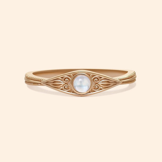 LIRAE moonstone ring featuring golden swirl filigree and an eye-shaped silhouette, ethereal vintage jewelry for women in gold.