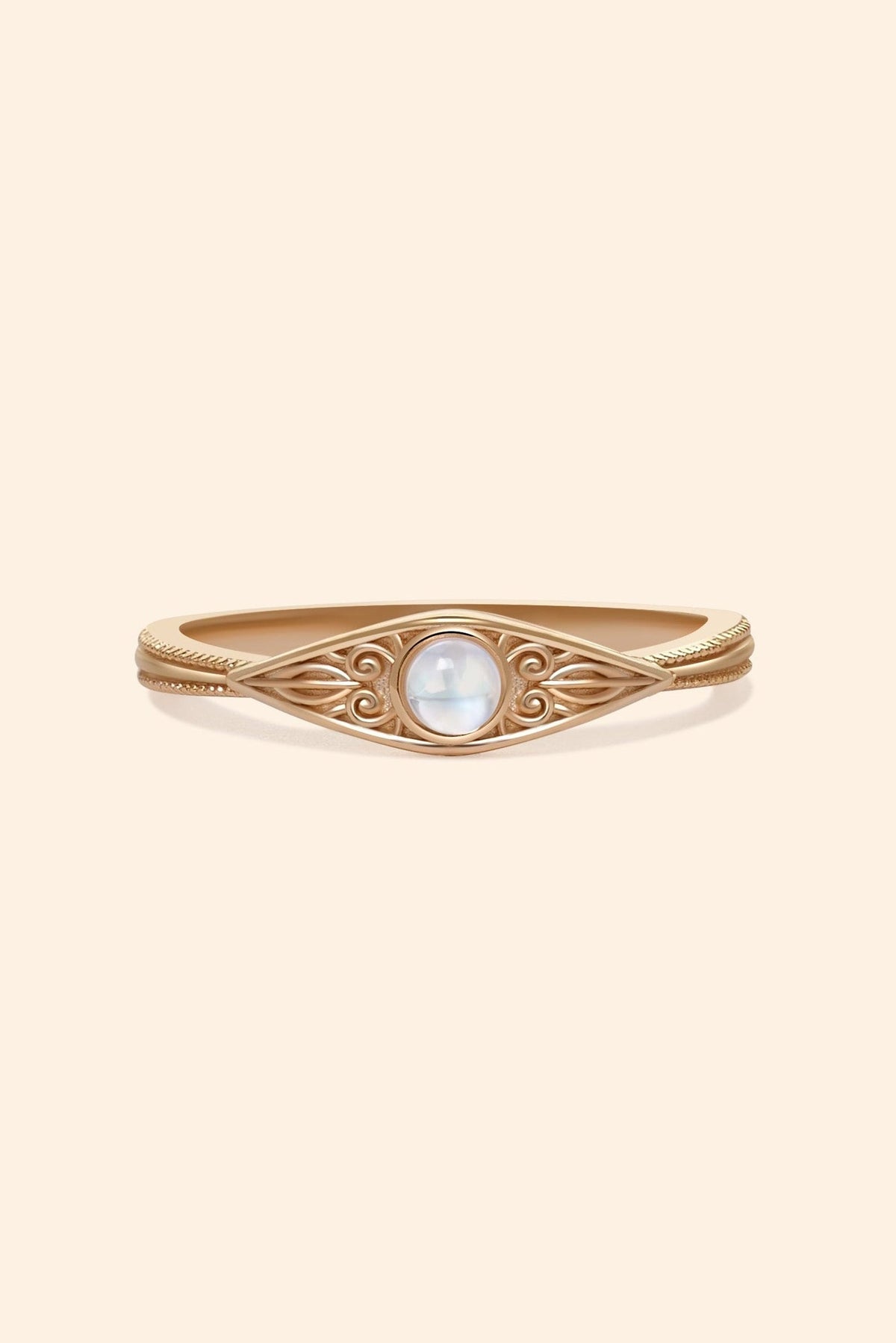 LIRAE moonstone ring featuring golden swirl filigree and an eye-shaped silhouette, ethereal vintage jewelry for women in gold.