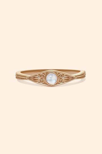 LIRAE moonstone ring featuring golden swirl filigree and an eye-shaped silhouette, ethereal vintage jewelry for women in gold.