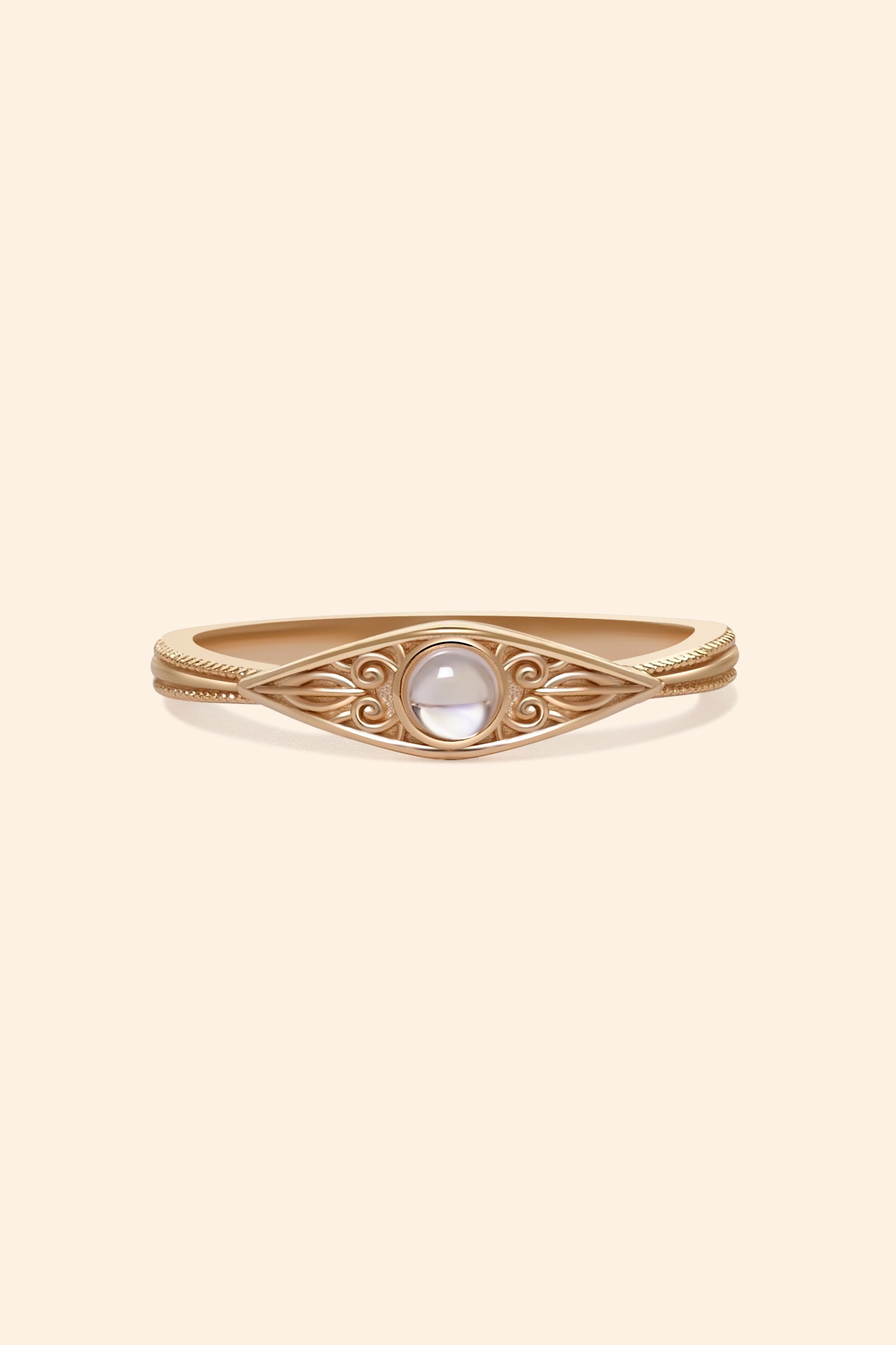LIRAE moonstone ring featuring golden swirl filigree and an eye-shaped silhouette, ethereal vintage jewelry for women in gold.