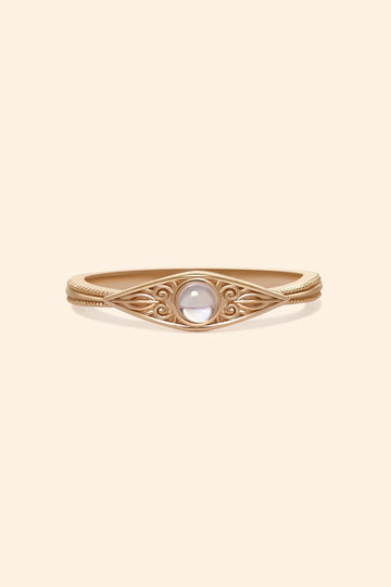 LIRAE moonstone ring featuring golden swirl filigree and an eye-shaped silhouette, ethereal vintage jewelry for women in gold.
