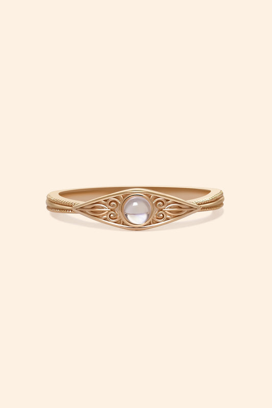 LIRAE moonstone ring featuring golden swirl filigree and an eye-shaped silhouette, ethereal vintage jewelry for women in gold.