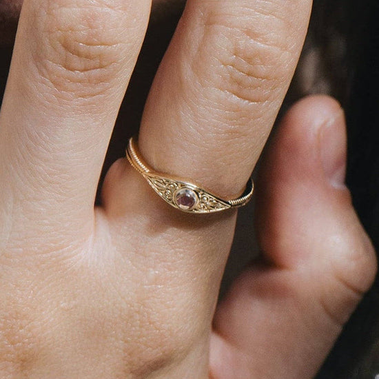 LIRAE moonstone ring featuring golden swirl filigree and an eye-shaped silhouette, ethereal vintage jewelry for women in gold.