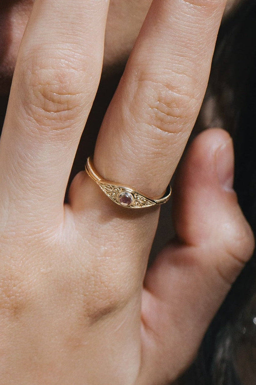LIRAE moonstone ring featuring golden swirl filigree and an eye-shaped silhouette, ethereal vintage jewelry for women in gold.