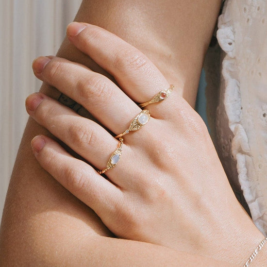 LIRAE moonstone ring featuring golden swirl filigree and an eye-shaped silhouette, ethereal vintage jewelry for women in gold.