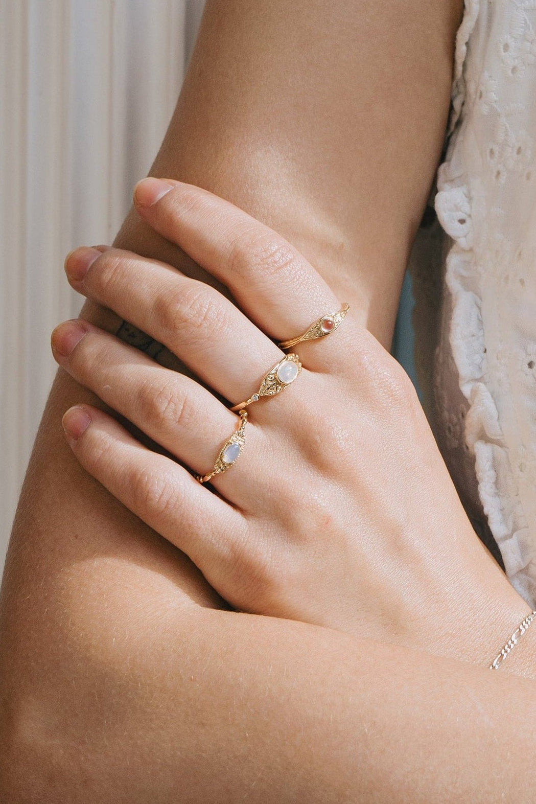 LIRAE moonstone ring featuring golden swirl filigree and an eye-shaped silhouette, ethereal vintage jewelry for women in gold.