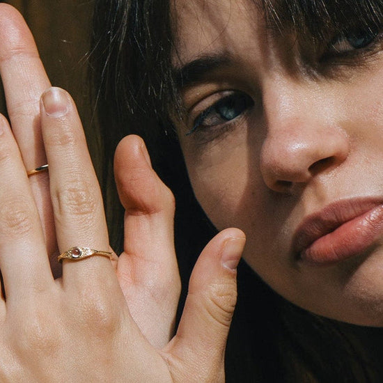 LIRAE moonstone ring featuring golden swirl filigree and an eye-shaped silhouette, ethereal vintage jewelry for women in gold.