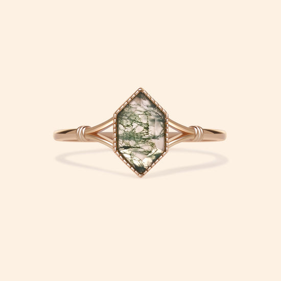 Moss agate ring with green inclusions on delicate gold band.