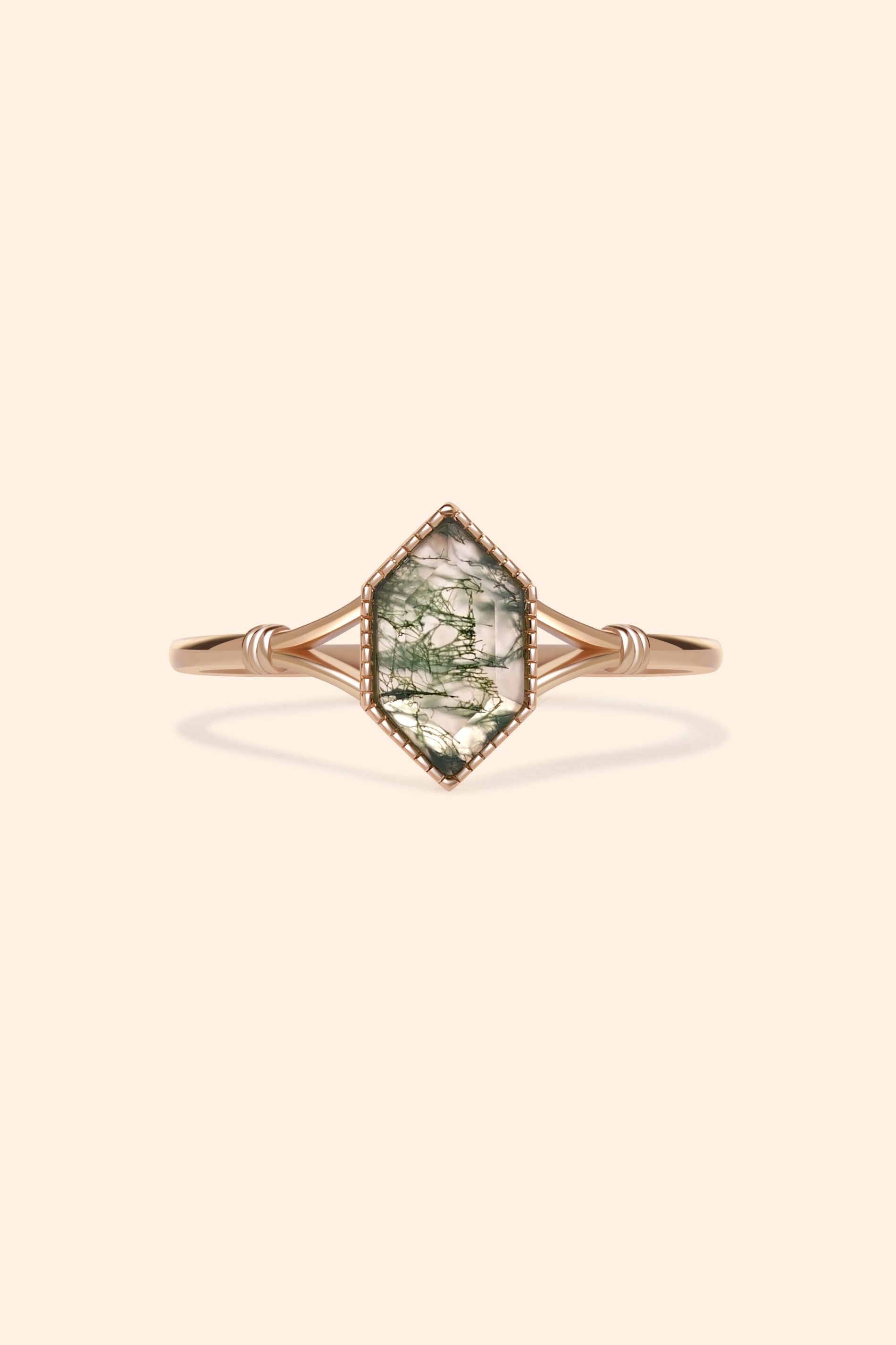 Moss agate ring with green inclusions on delicate gold band.