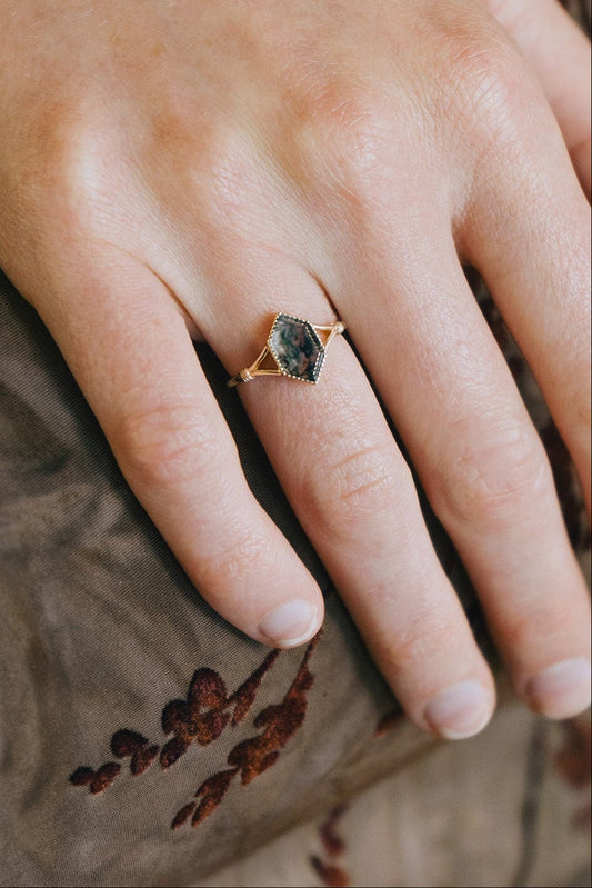 Moss agate ring with green inclusions on delicate gold band.