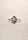 Moss agate ring with green inclusions on delicate gold band.