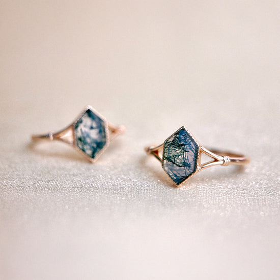 Moss agate ring with green inclusions on delicate gold band.

