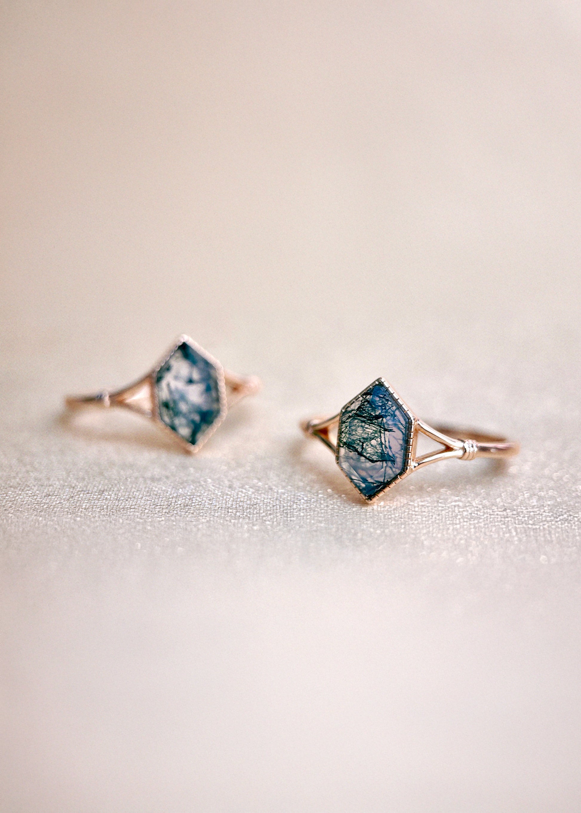 Moss agate ring with green inclusions on delicate gold band.
