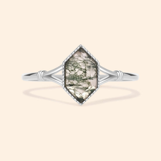 Moss agate ring with green inclusions on delicate silver band.