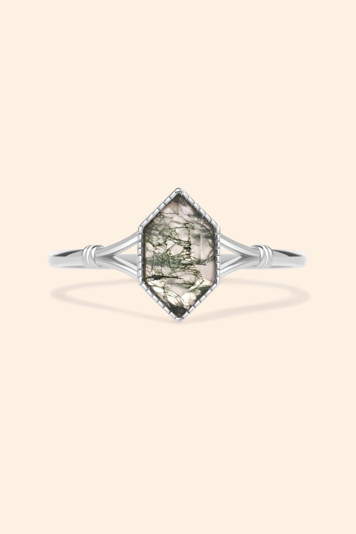 Moss agate ring with green inclusions on delicate silver band.